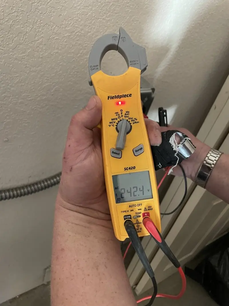 Voltage testing with clamp meter during Ceiling Fan Installation in Oakland